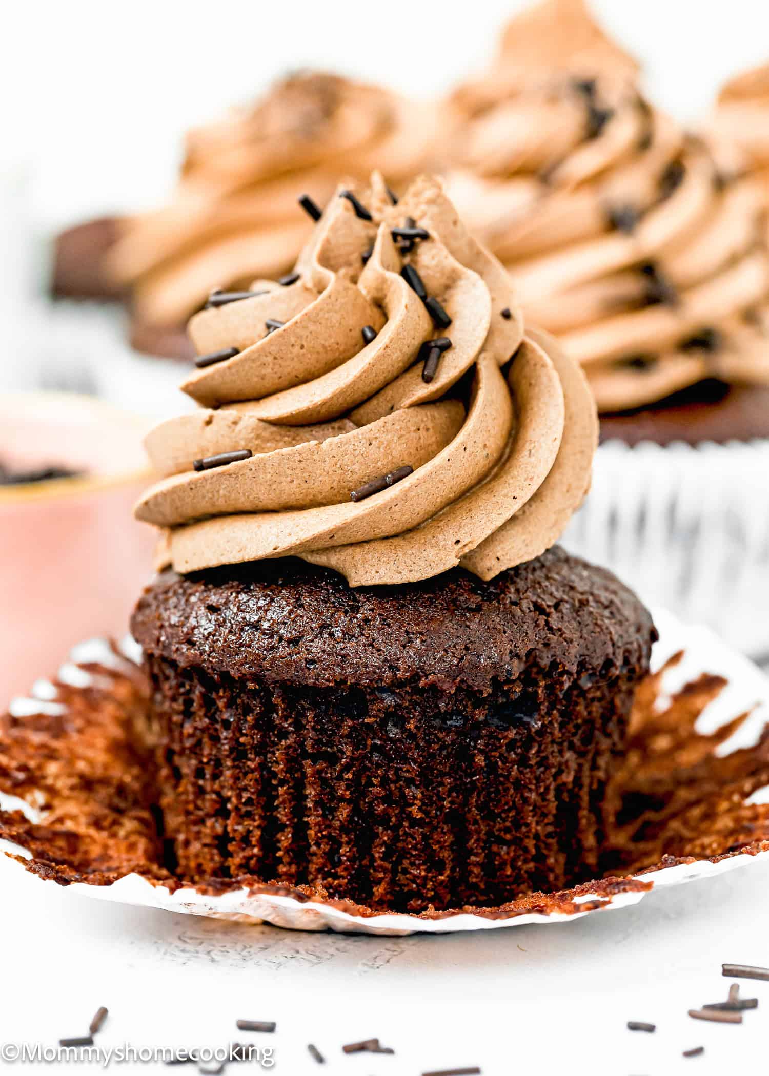 an Easy eggless and dairy-free Chocolate Cupcake with chocolates frosting and chocolate sprinkles.