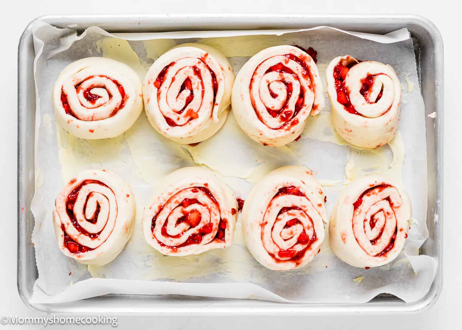 unbaked Strawberry Rolls in a baking tray.
