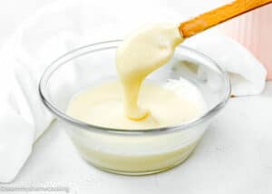 Cream Cheese Icing For Cinnamon Rolls in a bowl with a spatula.