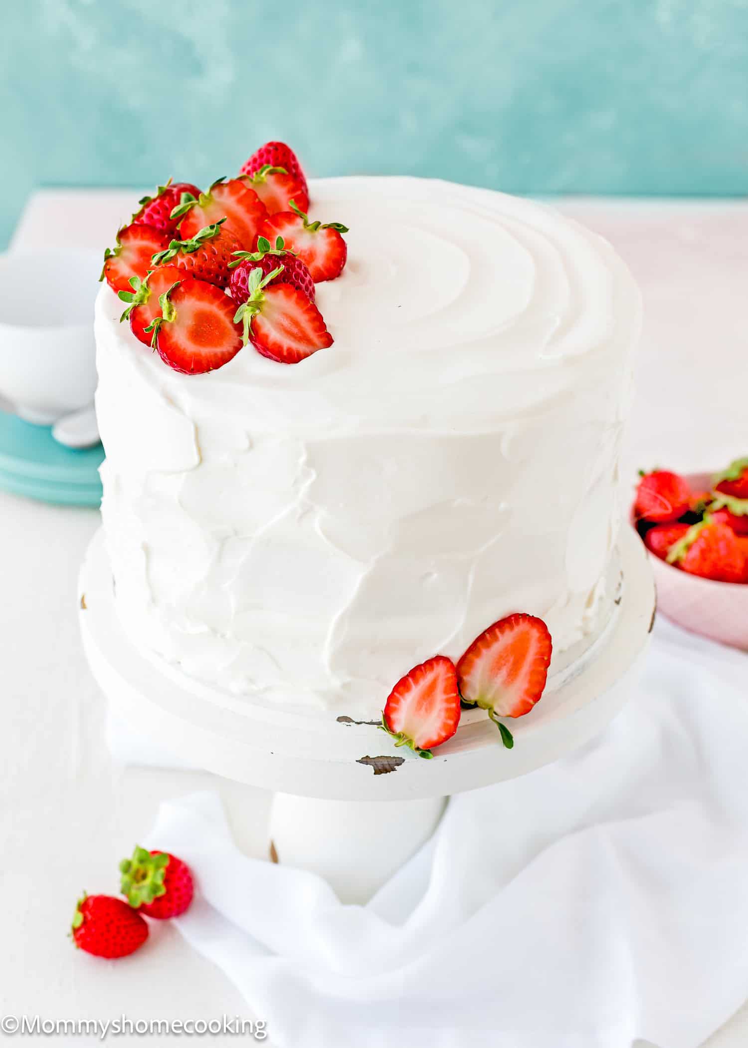 eggless strawberry shortcake cake decorated with Easy Whipped Cream Frosting and fresh strawberries.