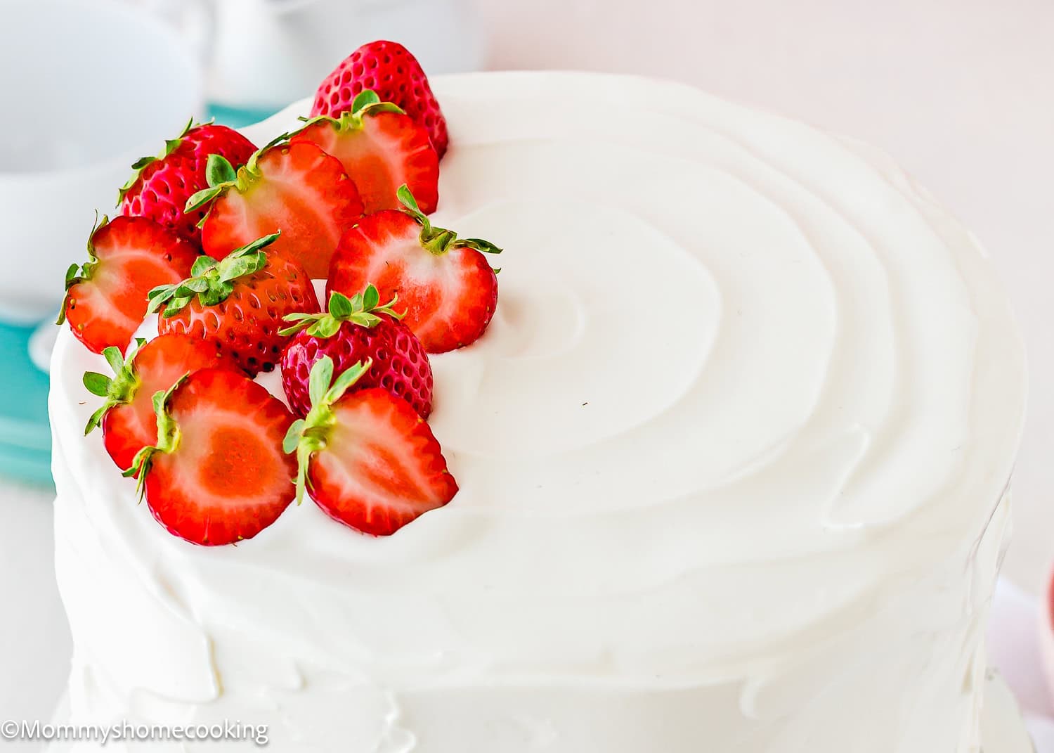 eggless strawberry shortcake cake decorated with Easy Whipped Cream Frosting and fresh strawberries.