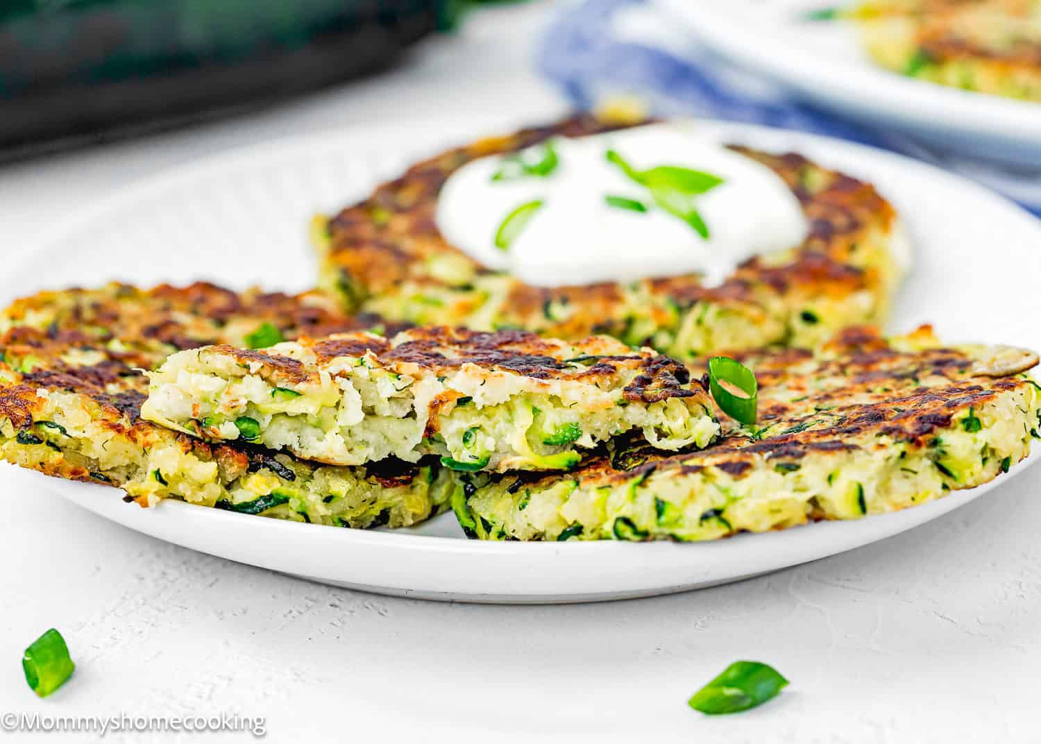 Four Eggless Zucchini Fritters on a plate showing its perfect crispy and tender texture.