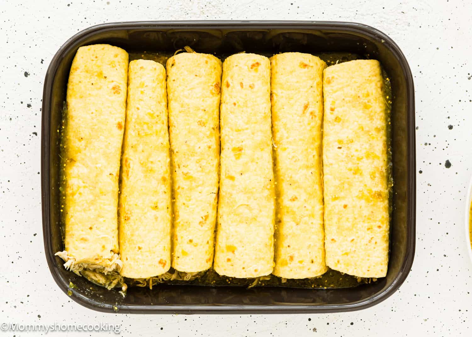 unbaked Enchiladas Suizas in a casserole dish.