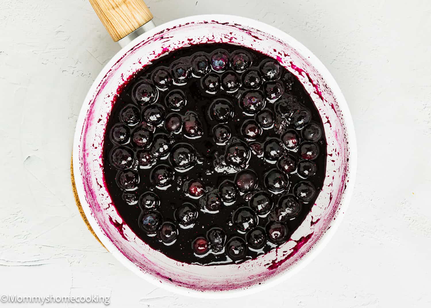 Homemade Blueberry Sauce Topping in a white small skillet.