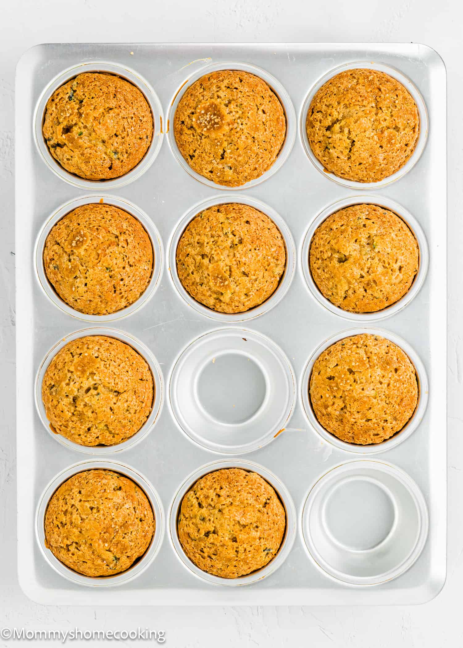 baked Simple Vegan Zucchini Muffins in a muffin tin.