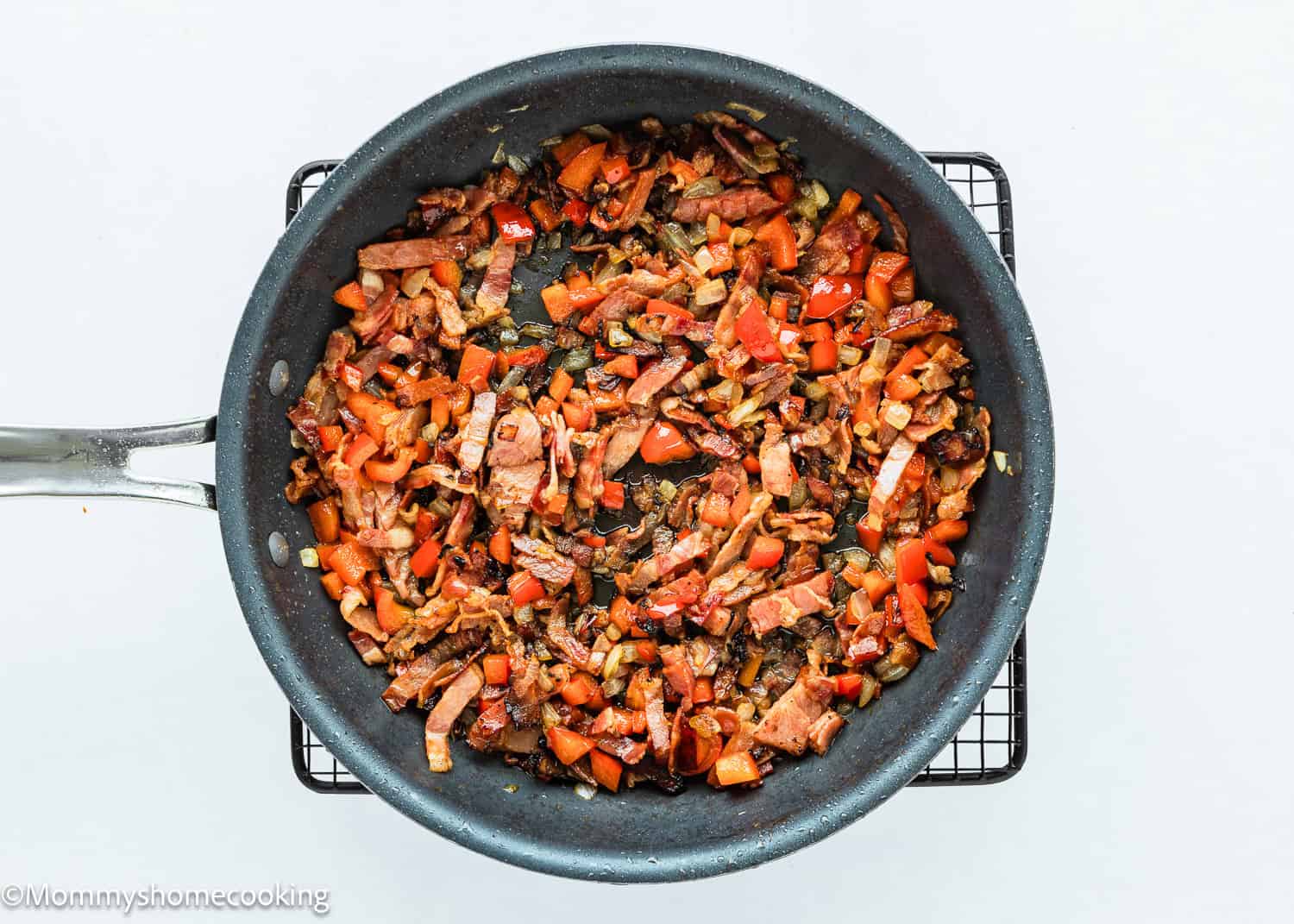 Sauté bacon and veggies to make Breakfast Casserole Without Eggs in a skillet.
