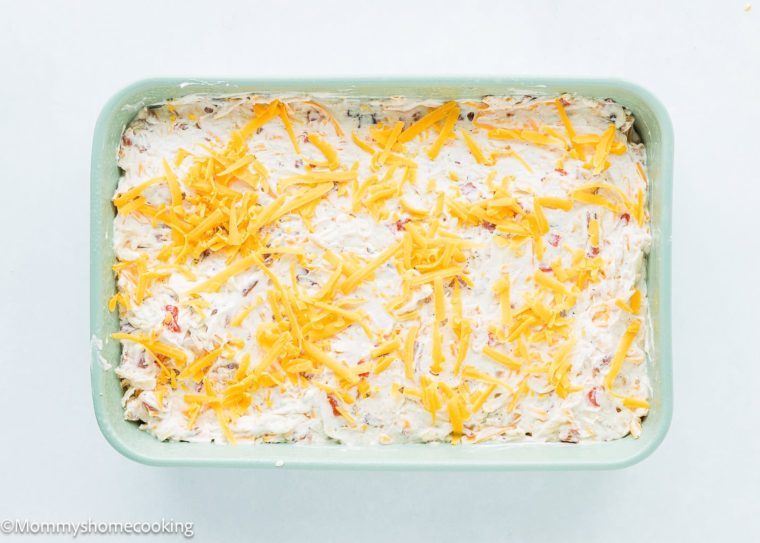 overhead view of a unbaked Breakfast Casserole Without Eggs with cheese on top.