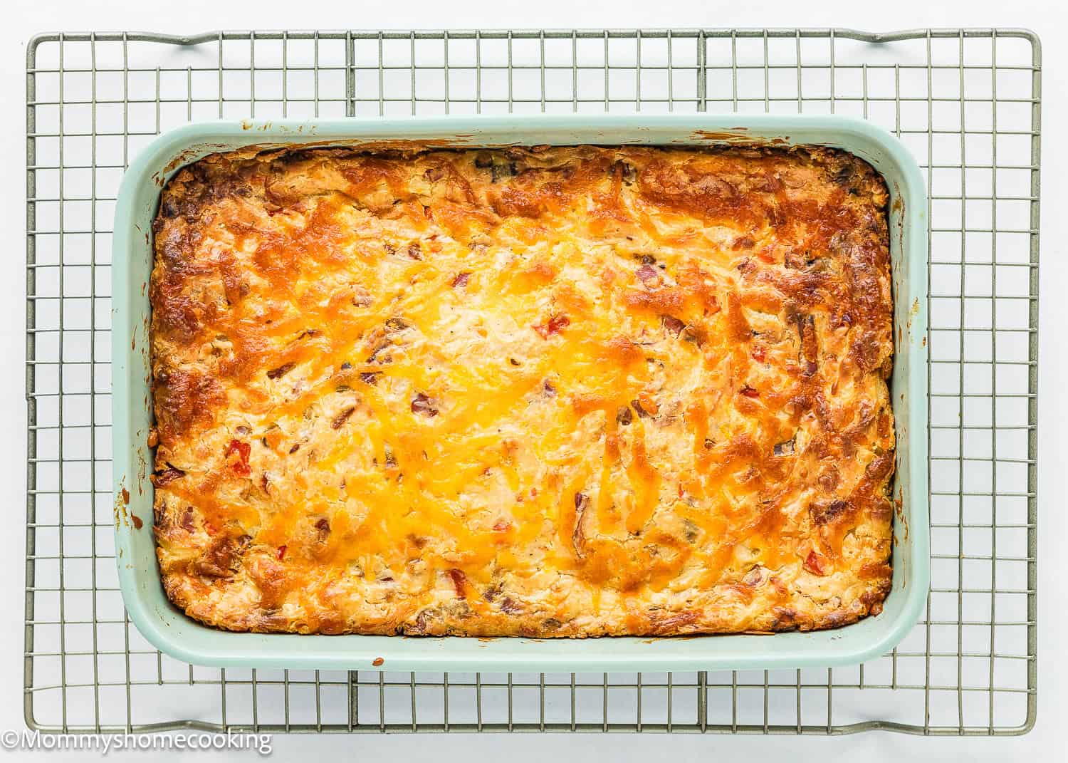 overhead view of a baked Breakfast Casserole Without Eggs over a cooling rack.