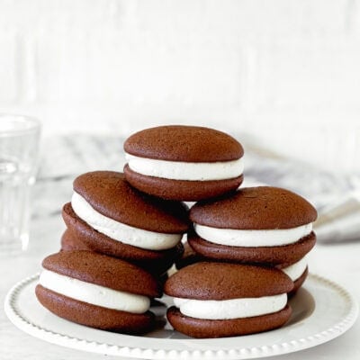 Fluffy and easy to make Chocolate Whoopie Pies without eggs over a white plate.