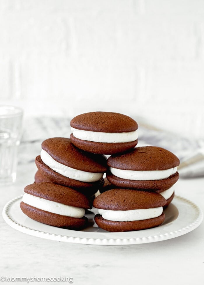 Fluffy and easy to make Chocolate Whoopie Pies without eggs over a white plate.