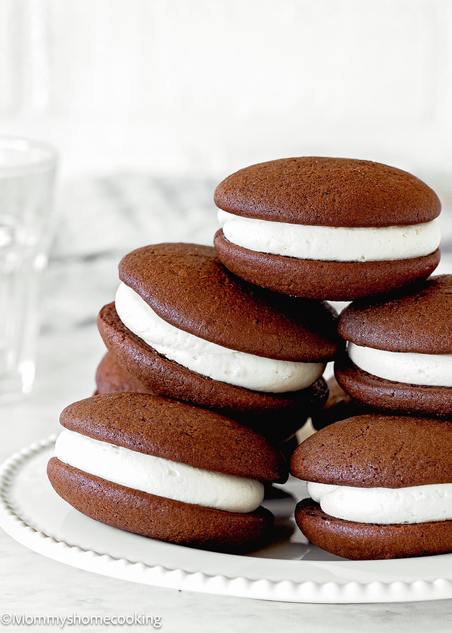 Stack of Egg-Free Chocolate Whoopie Pies over a white plate.