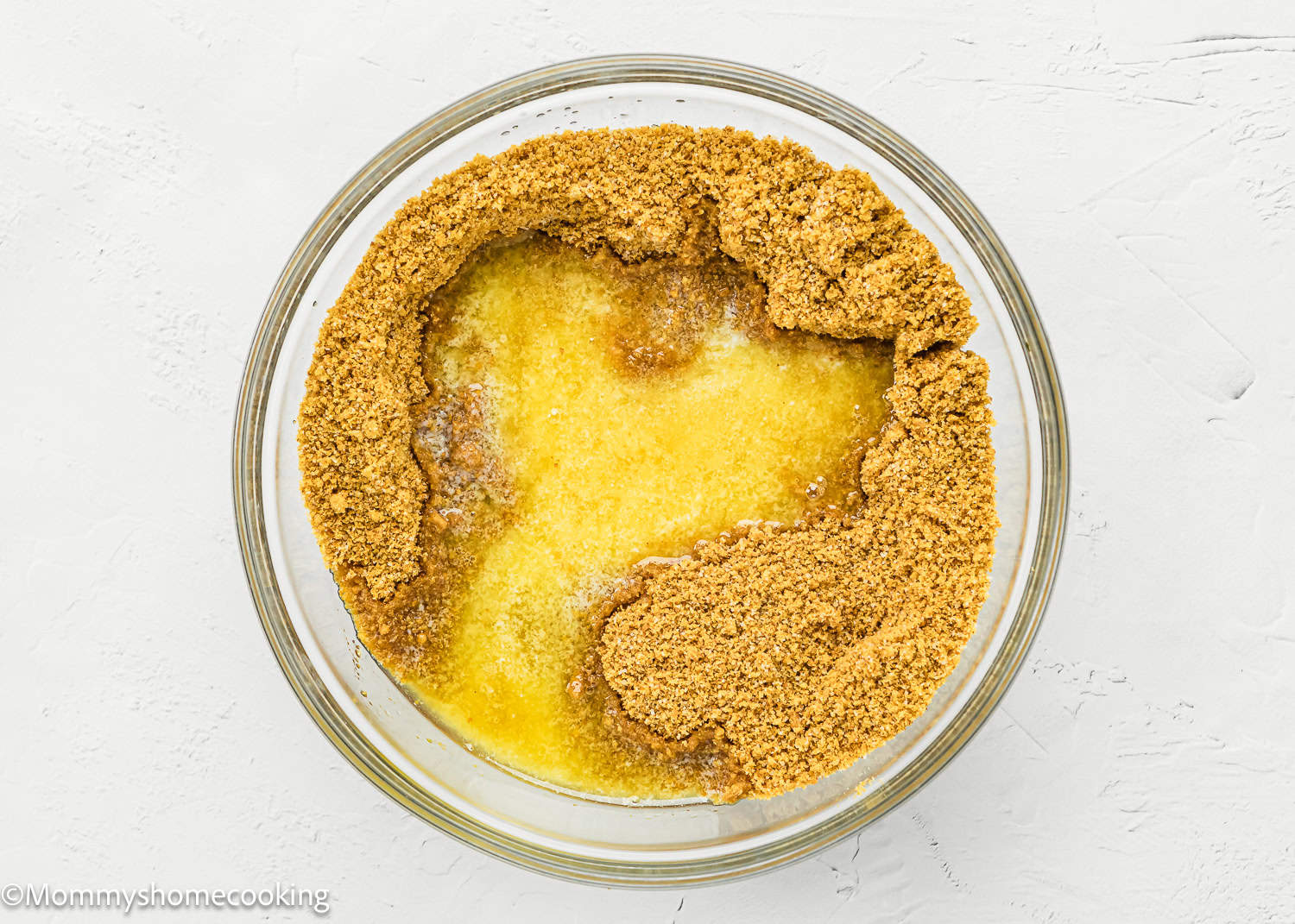 graham cracker crumbs, sugar and melted butter in a bowl.