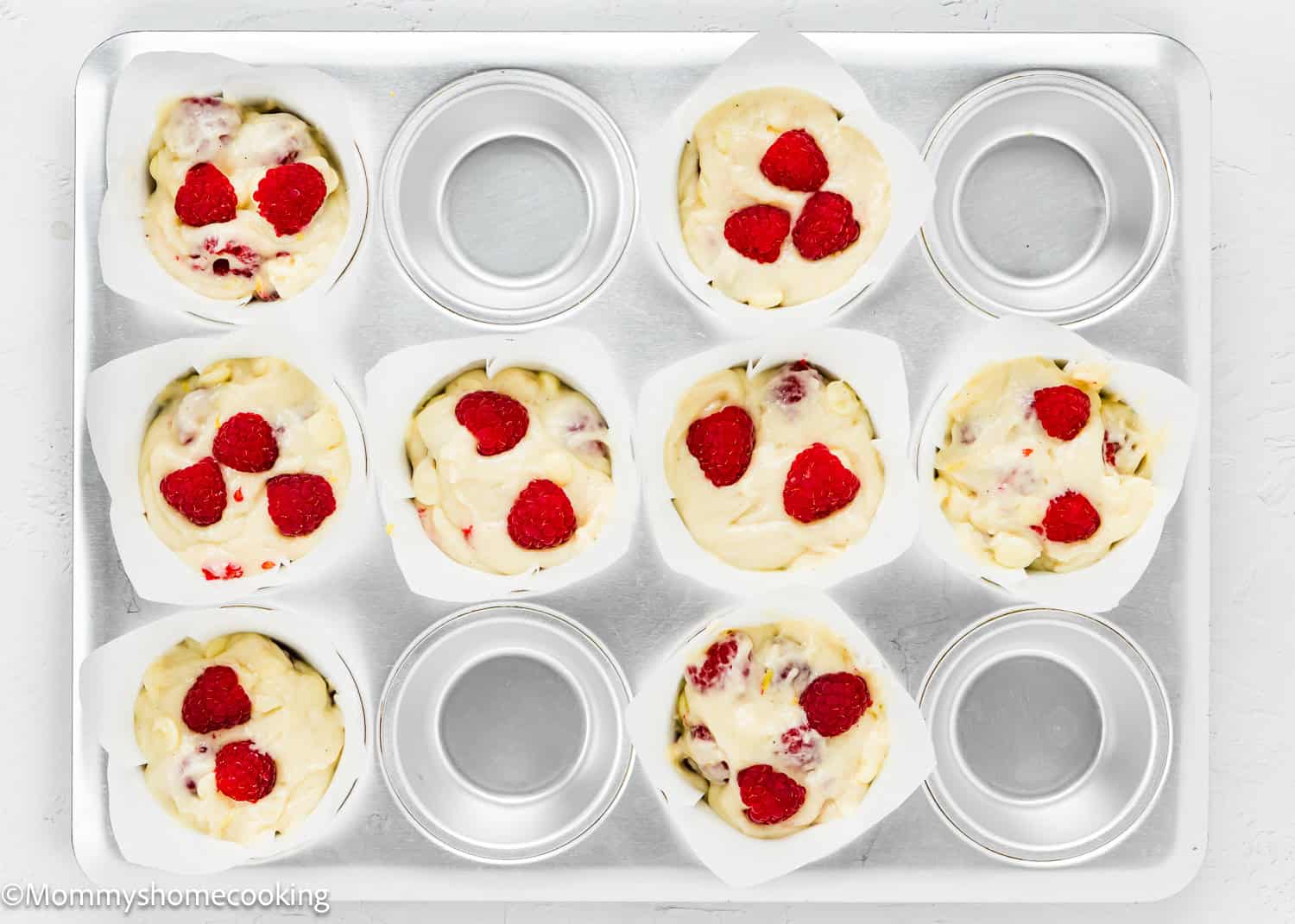 unbaked Easy Vegan Raspberry Muffins in a muffins tin.