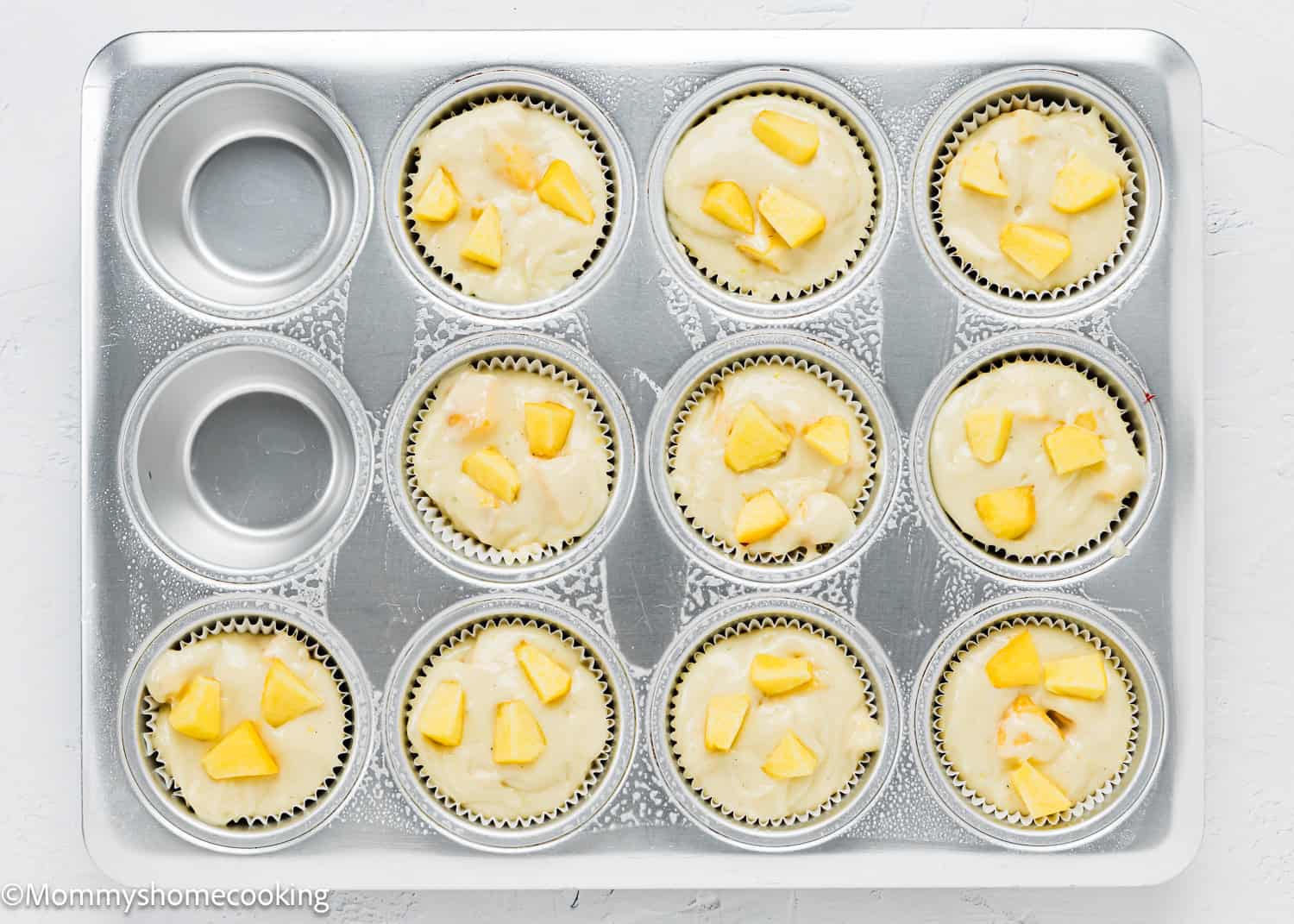 unbaked Easy Peach Muffins in a muffin pan.
