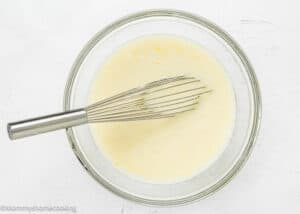 wet ingredients to make Eggless Easy Peach Muffins mix together in a bowl.