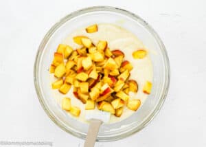 Easy Peach Muffins batter in a bowl with a spatula.