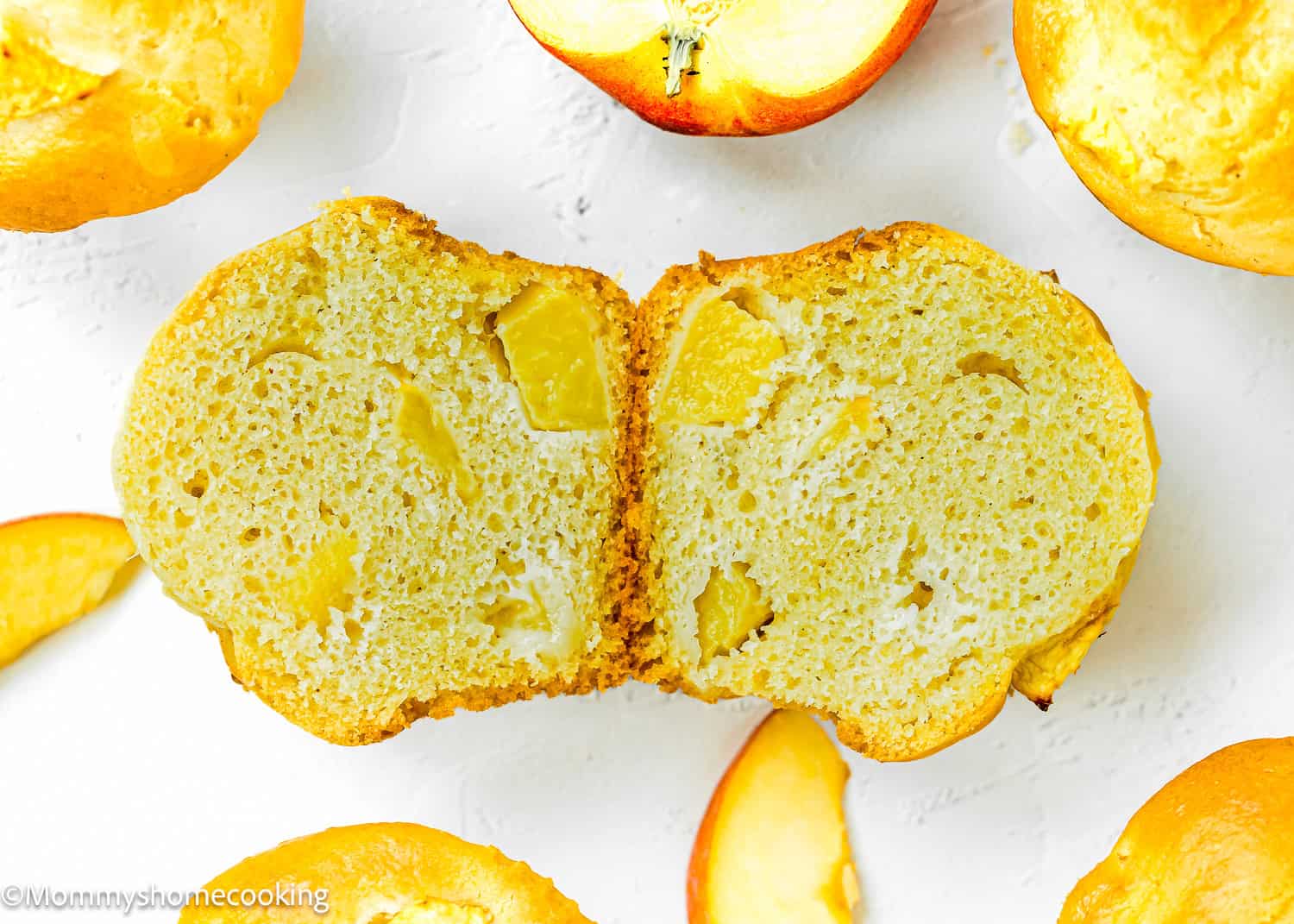 a Easy Peach Muffin made without eggs and dairy cut in half showing its inside texture.