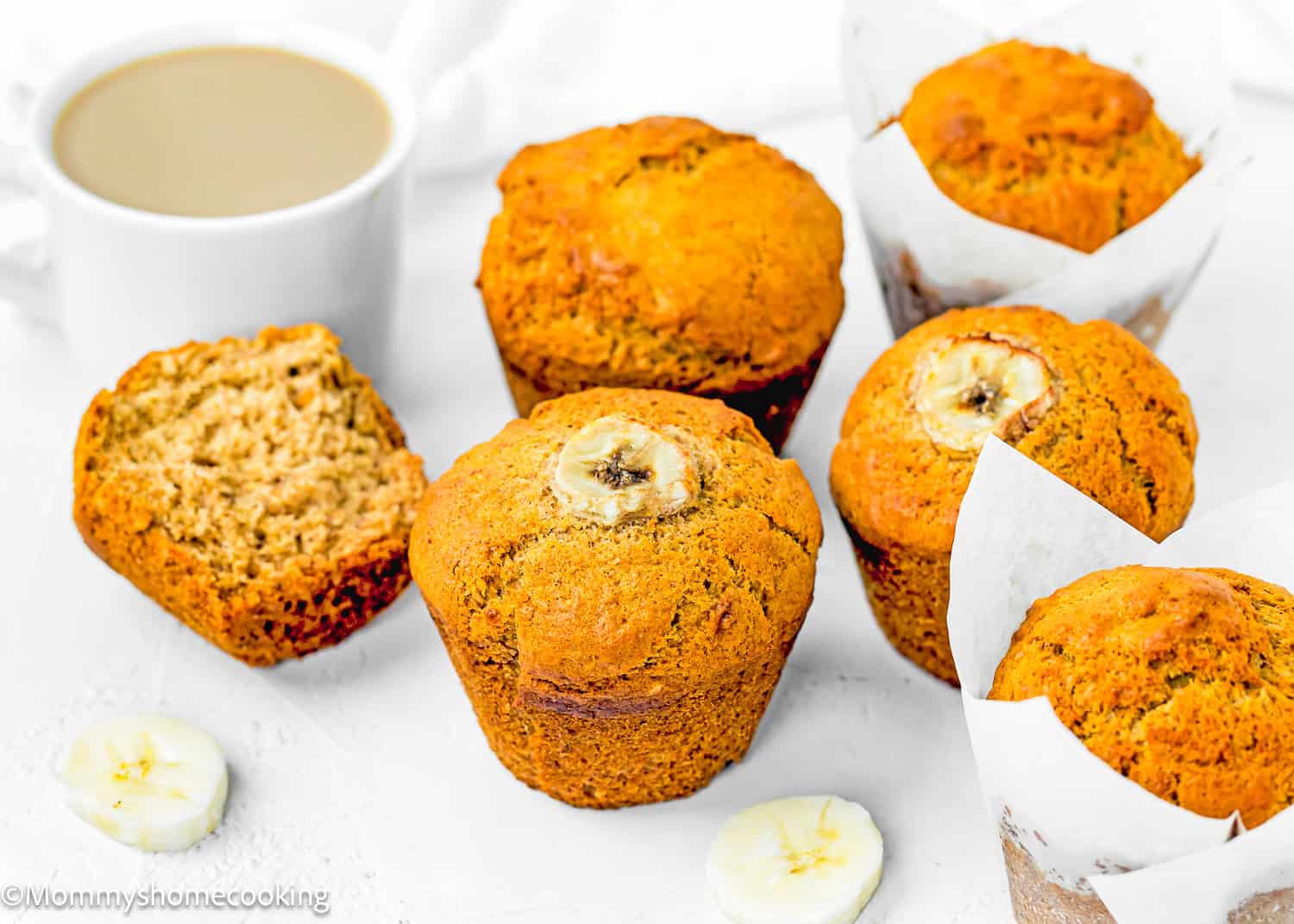 A Vegan Easy Banana Muffins on a small plate with a cup of coffee in the background.