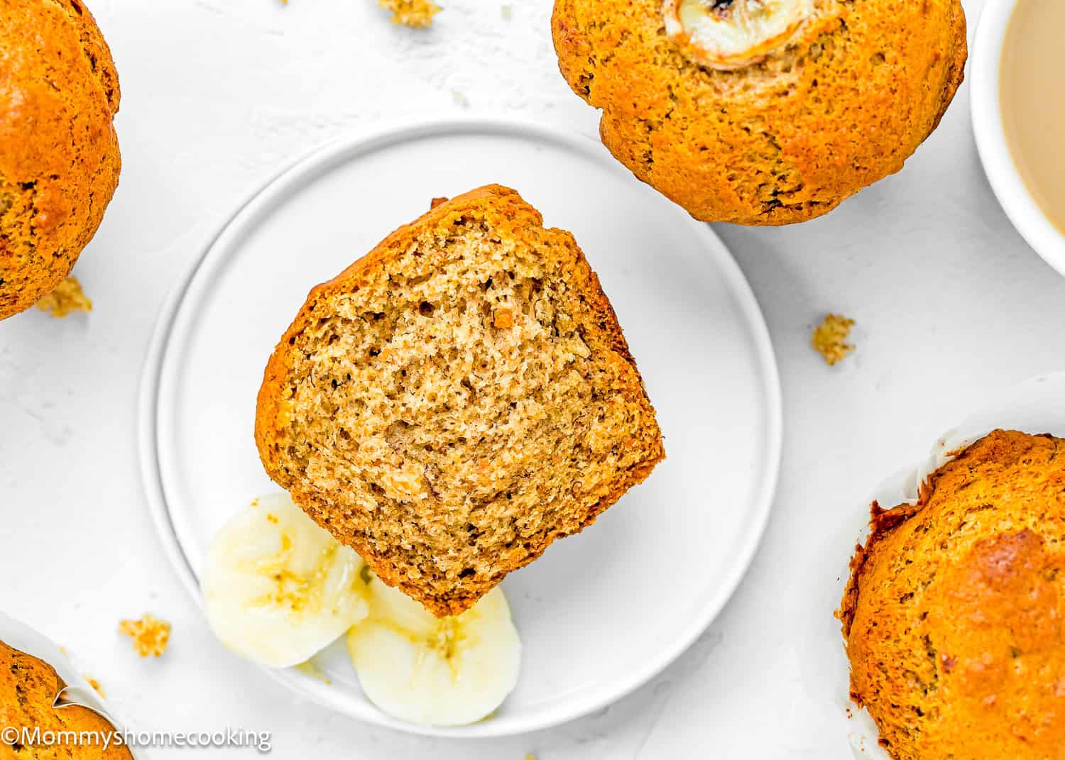 A Healthy Easy Banana Muffin cut in half made with no sugar, eggs or dairy on a small plate.