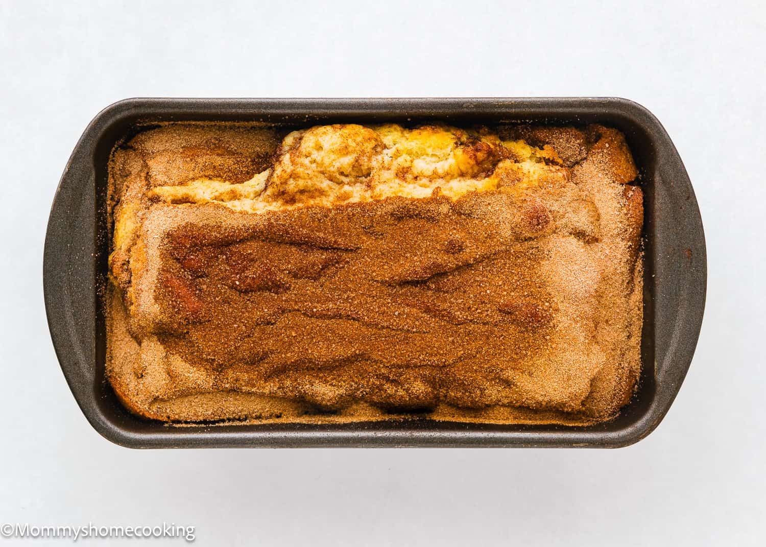 a whole baked Vegan Cinnamon Swirl Quick Bread in a loaf pan.
