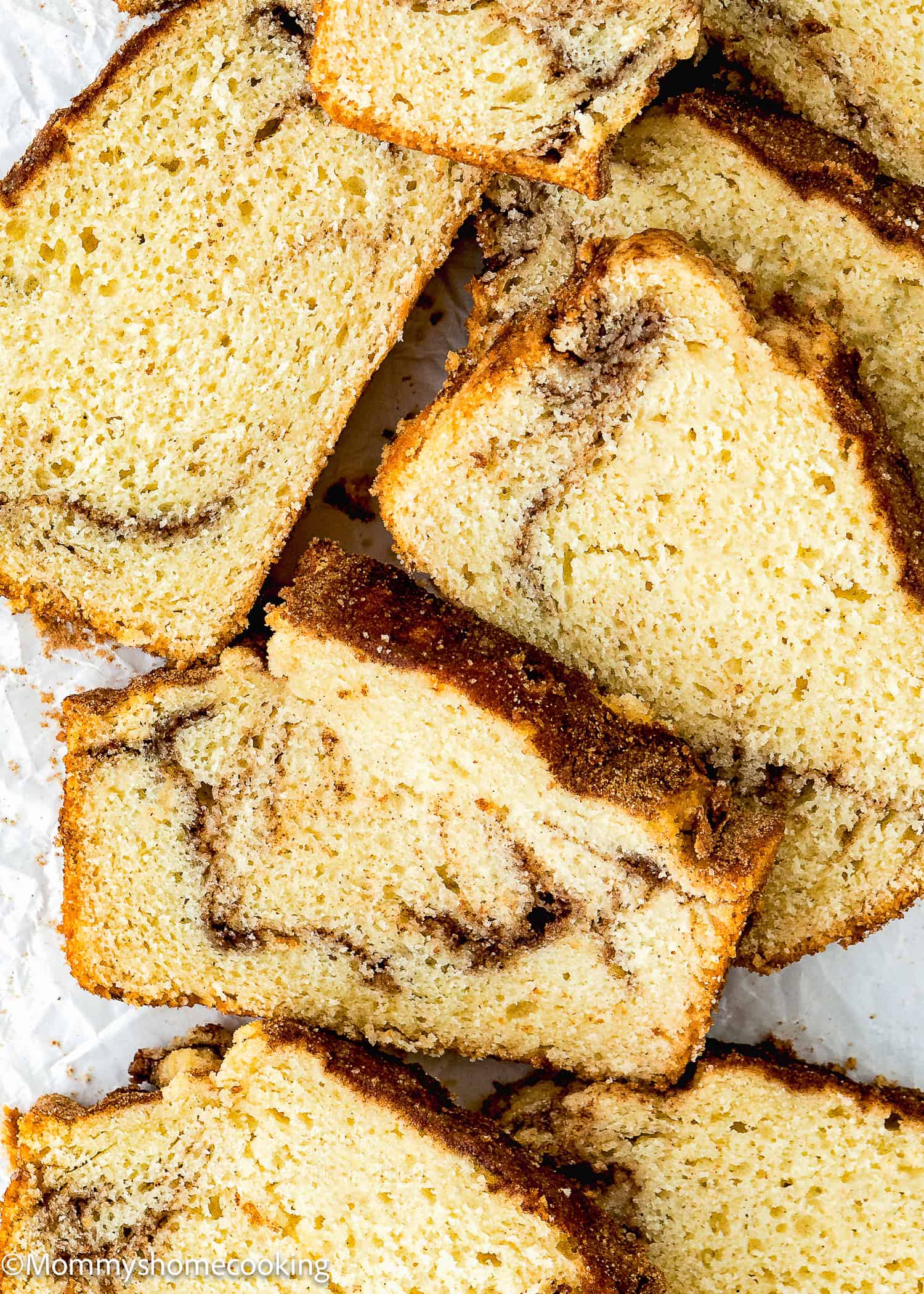 slices of Vegan Cinnamon Swirl Quick Bread sliced showing its perfect inside texture over a white surface.