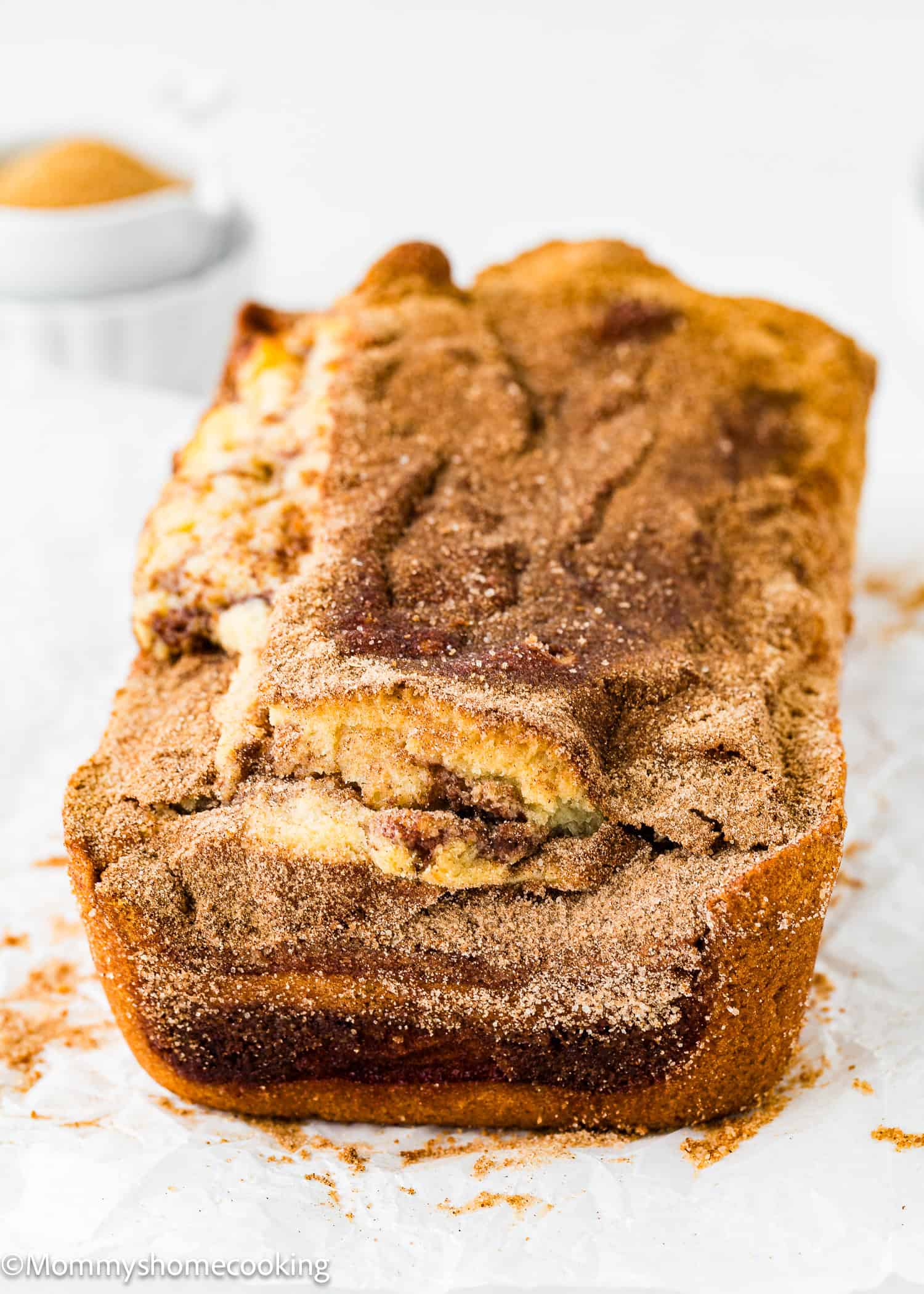 a whole egg and dairy free Cinnamon Swirl Quick Bread over a white surface.