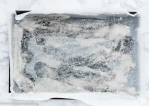 baking tray covered in parchment paper and greased to make Eggless Easy Chocolate Swiss Roll Cake.