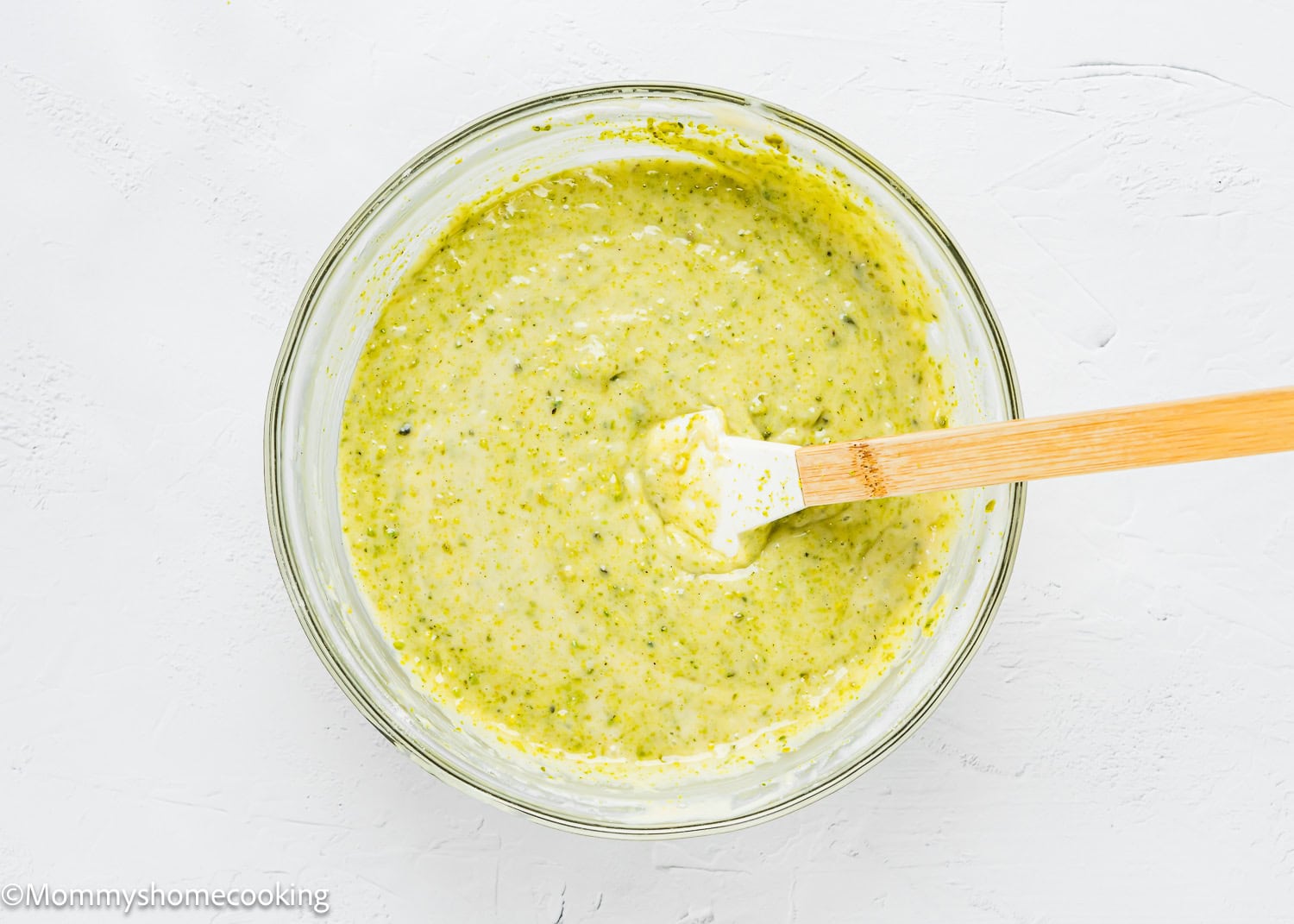 eggless Easy Pistachio Cake batter in a bowl with a spatula.