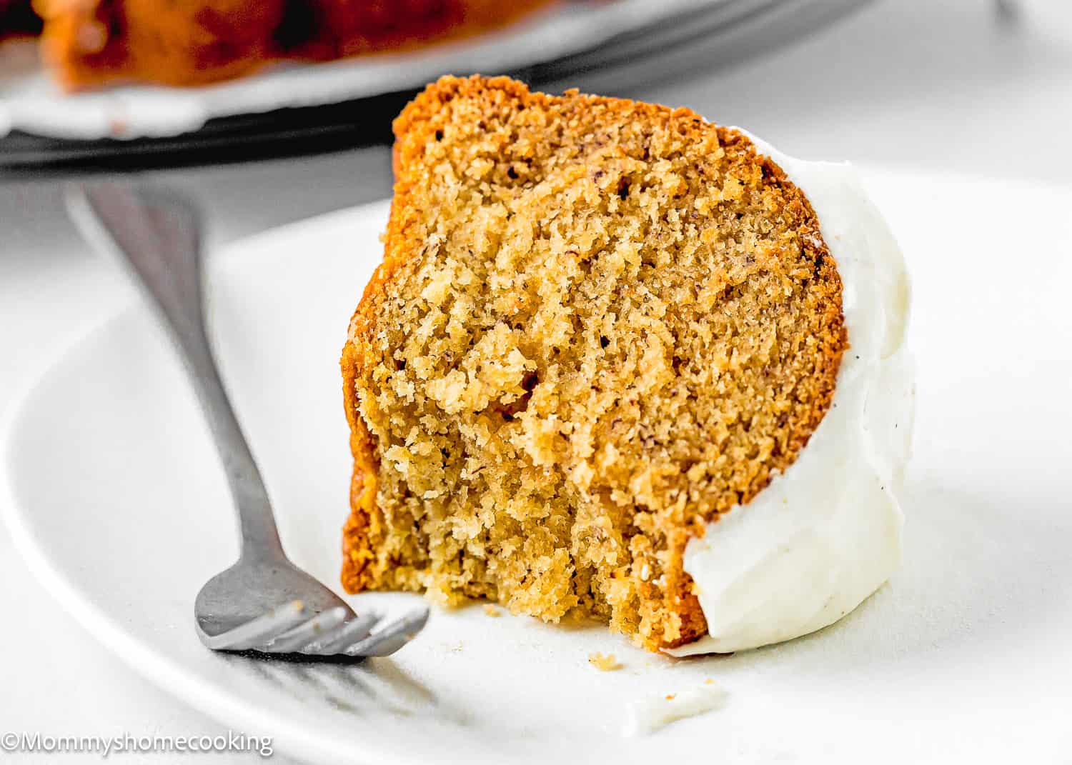 a slice Eggless Brown Butter Banana Bundt Cake on a plate with a fork.