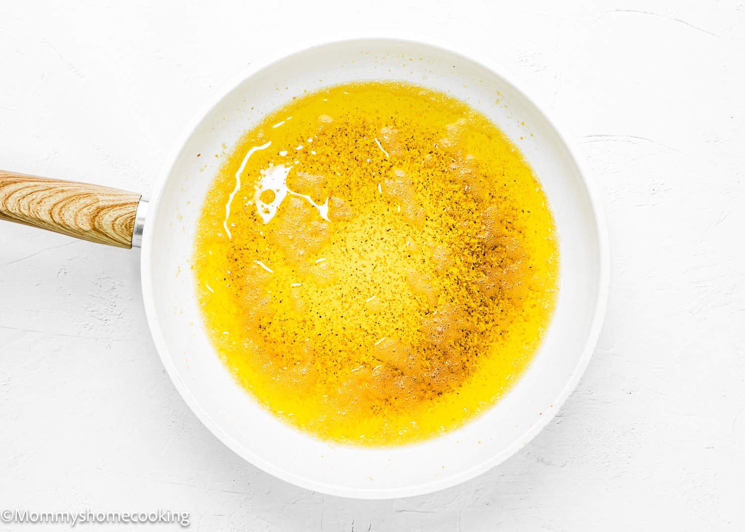 brown butter in a white skillet over a white surface.