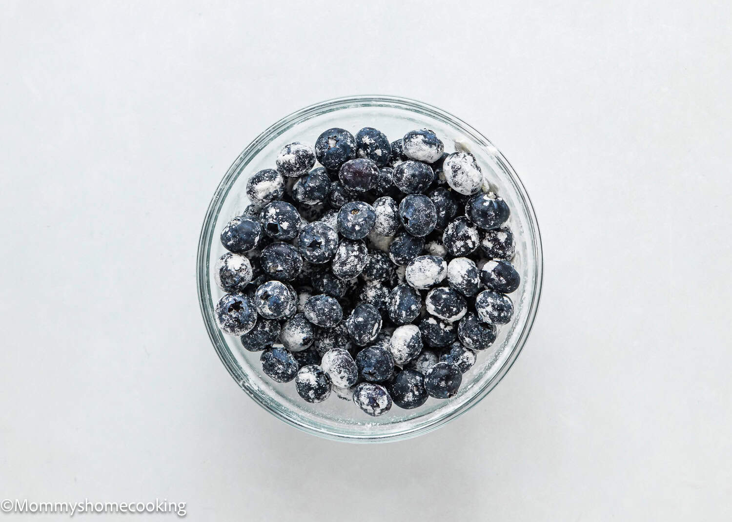 blueberries tossed with flour in a bowl.