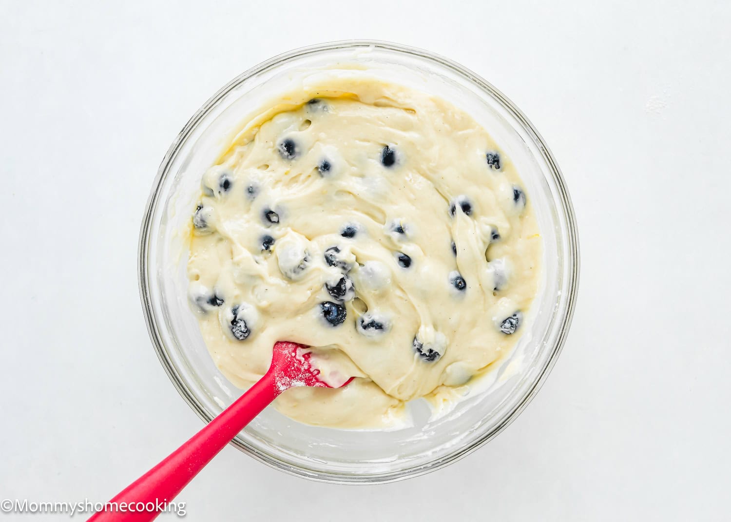 Easy Vegan Blueberry Muffins batter in a bowl with a spatula.