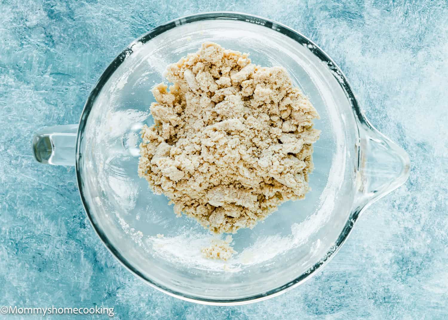 Eggless Cookie dough in a stand mixer bowl over a blue surface.