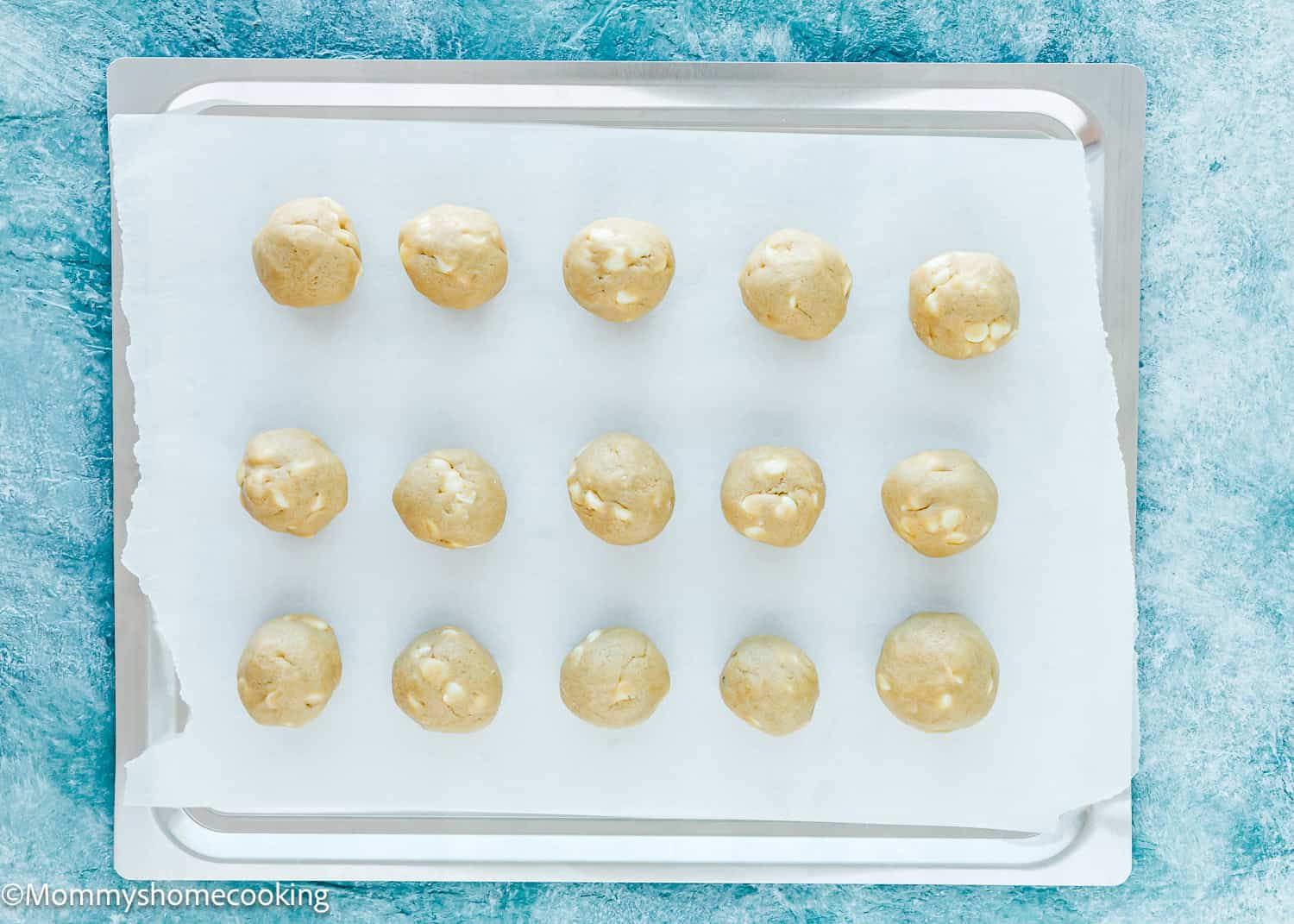 Eggless White Chocolate Cookie dough balls in a baking sheet.