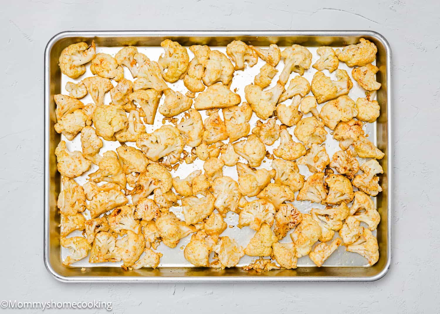 A baking tray filled with quick and easy roasted cauliflower florets.