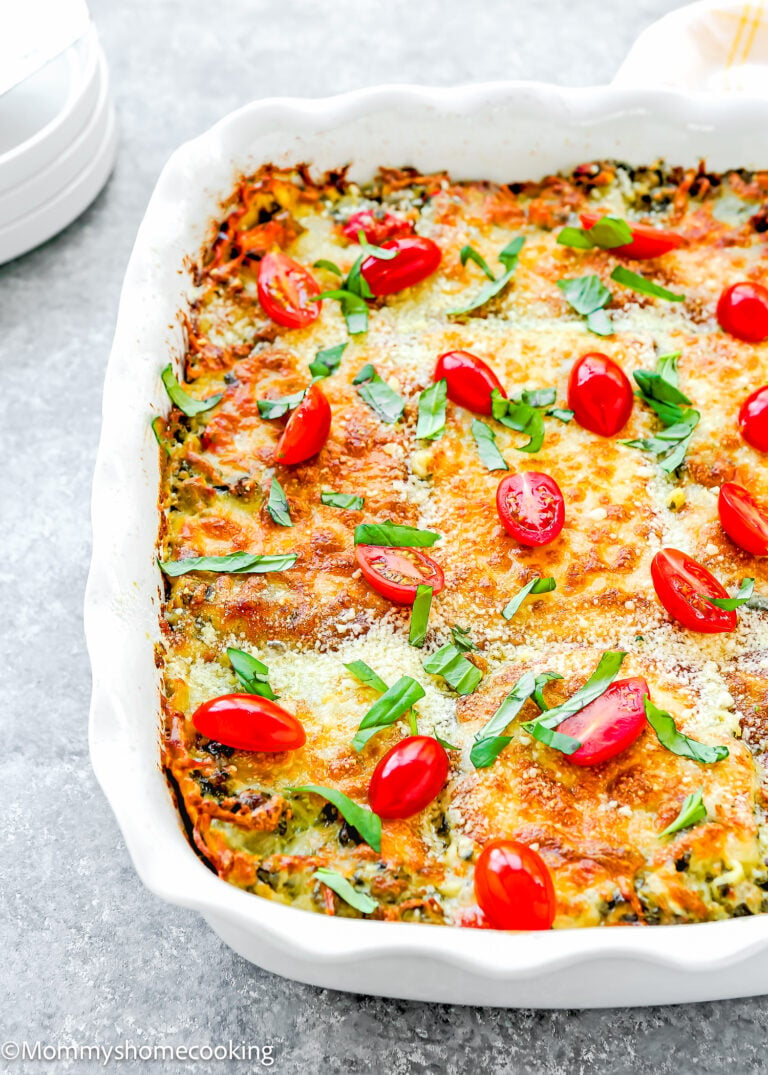 Easy White Turkey Lasagna: a baked casserole topped with melted cheese, sliced cherry tomatoes, and chopped herbs, all served in a classic white dish.