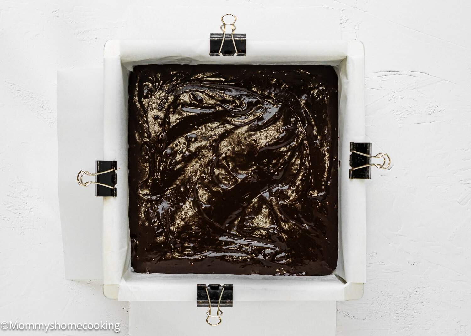 chocolate batter in s square baking pan. 