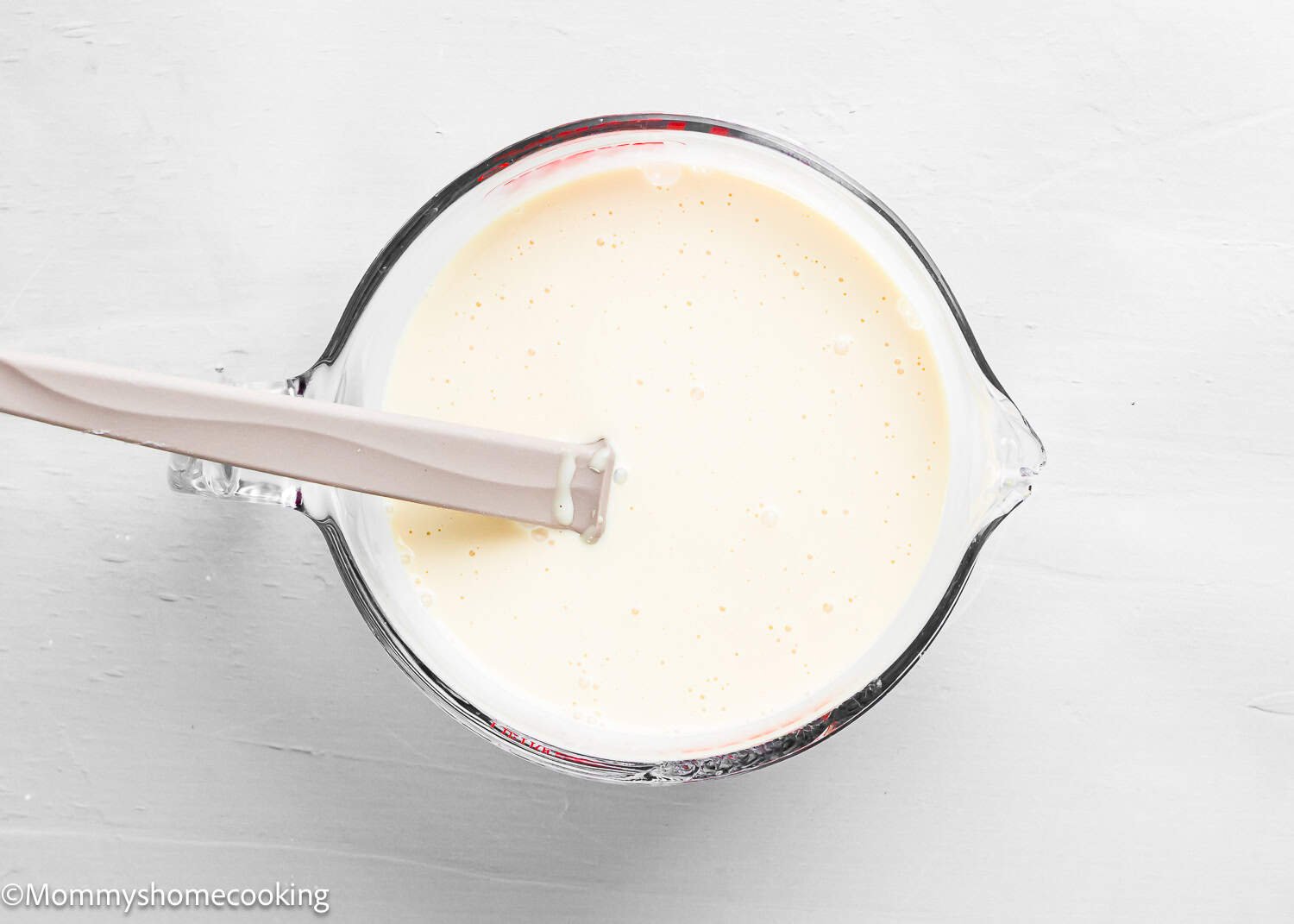 a bowl with milk mixture for The Best Eggless Tres Leches Cake.