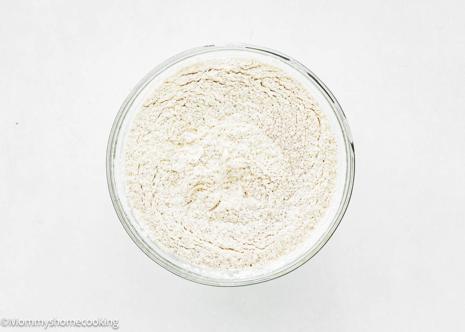 dry ingredients to make Eggless Easy Apple Upside Down Cake in a bowl.