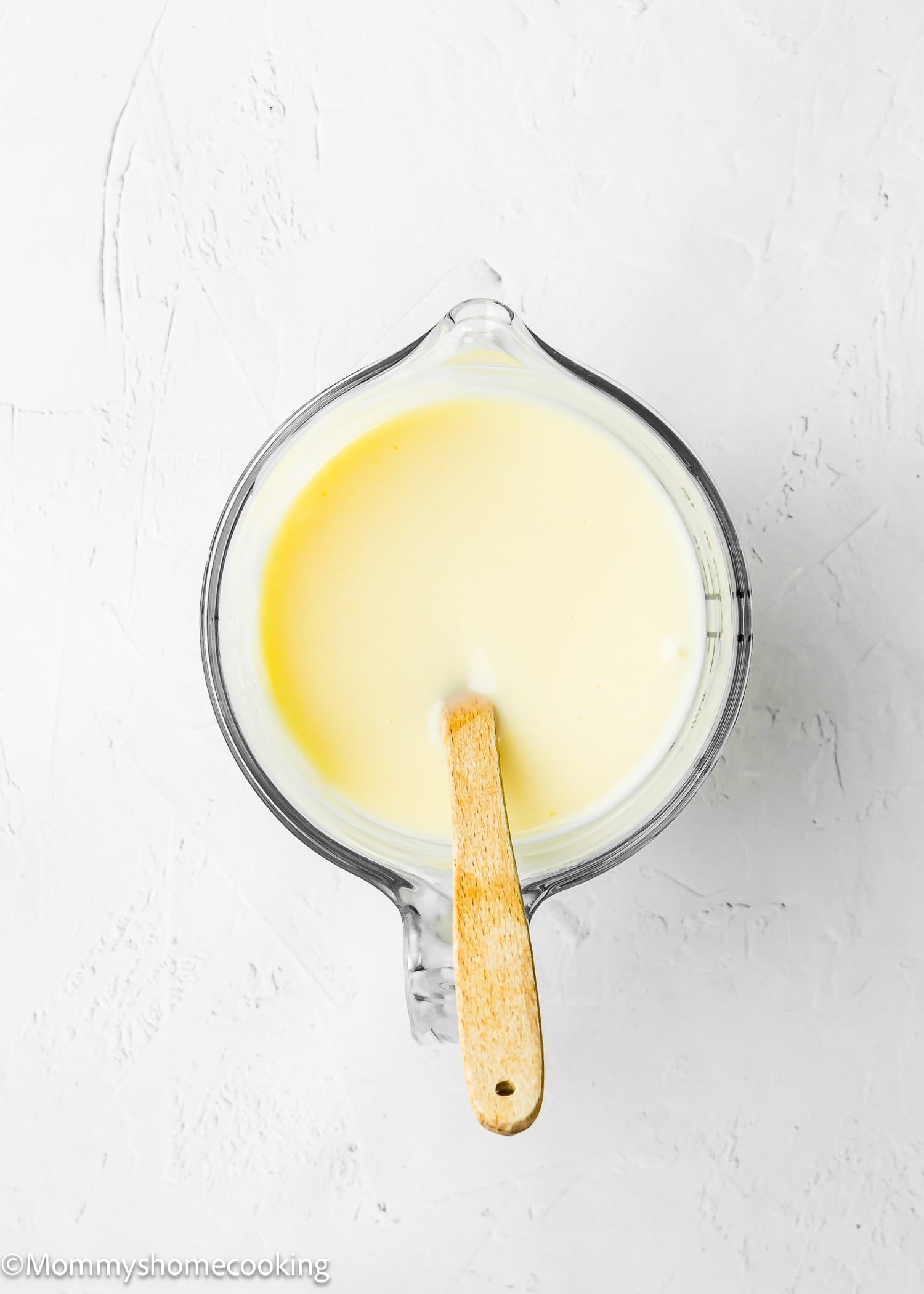 lemon sauce in a bowl to make Eggless Lemon Poke Cake.