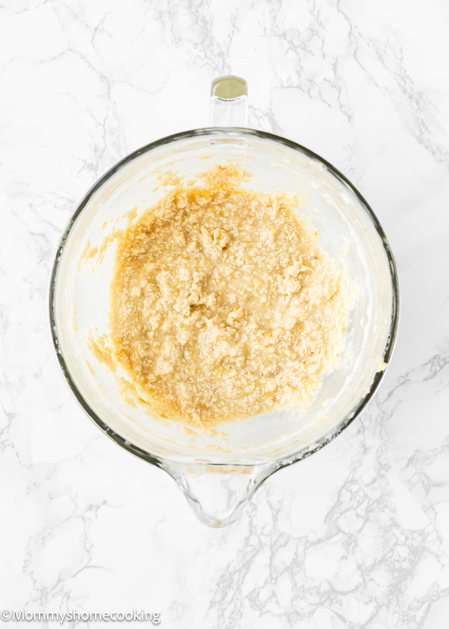 wet ingredients make Eggless Banana Layer Cake in a stand mixer bowl.