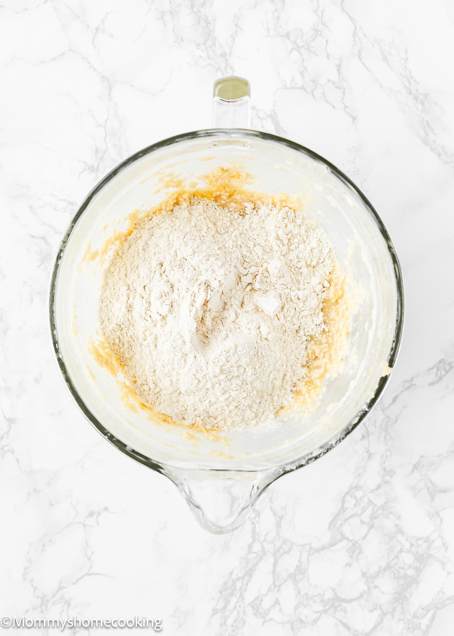 dry and wet ingredients to make Eggless Banana Layer Cake in a stand mixer bowl.