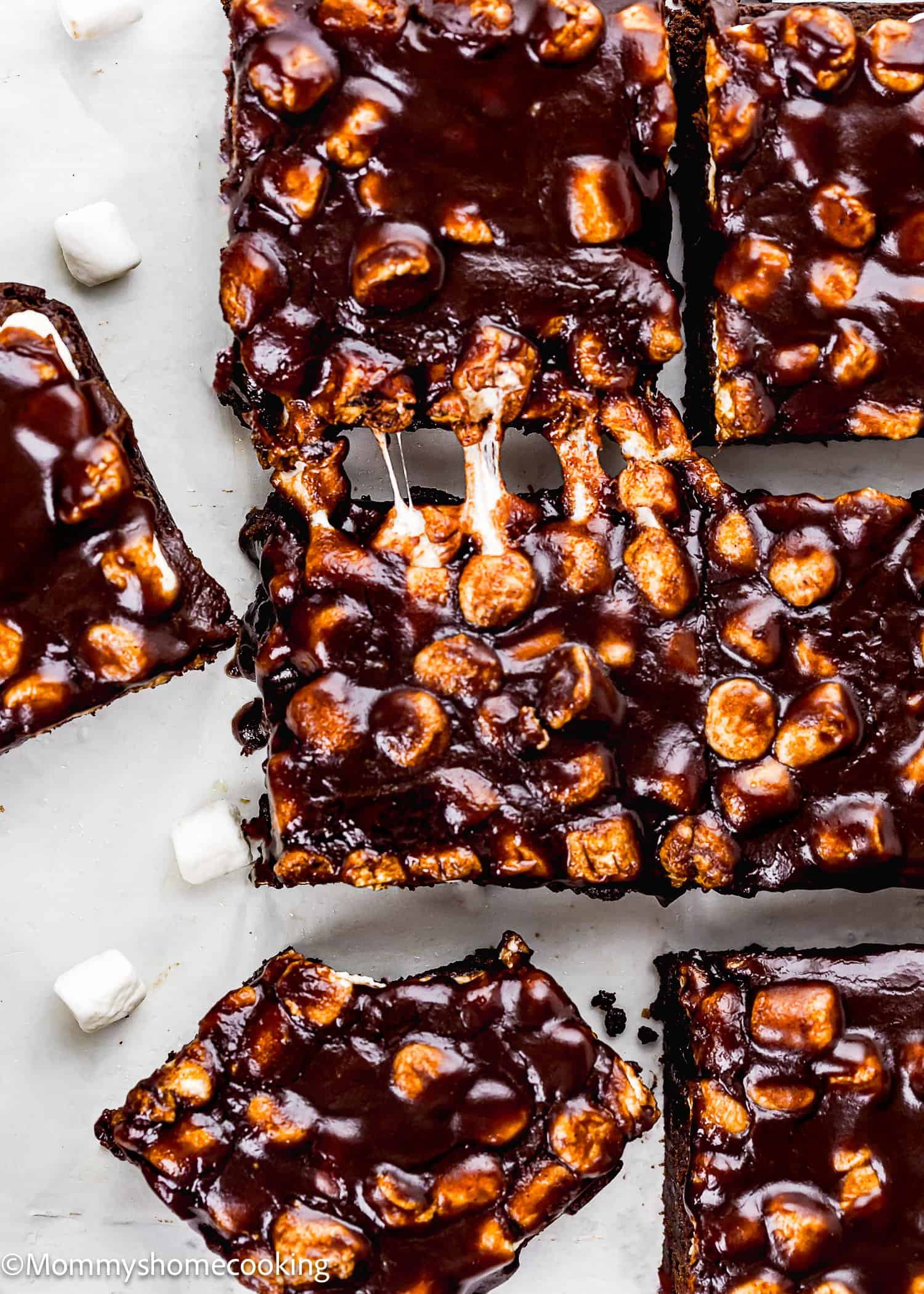 Egg-Free Chocolate marshmallow Brownies squares, some cut into pieces, with a glossy chocolate coating and mini marshmallows visible throughout.