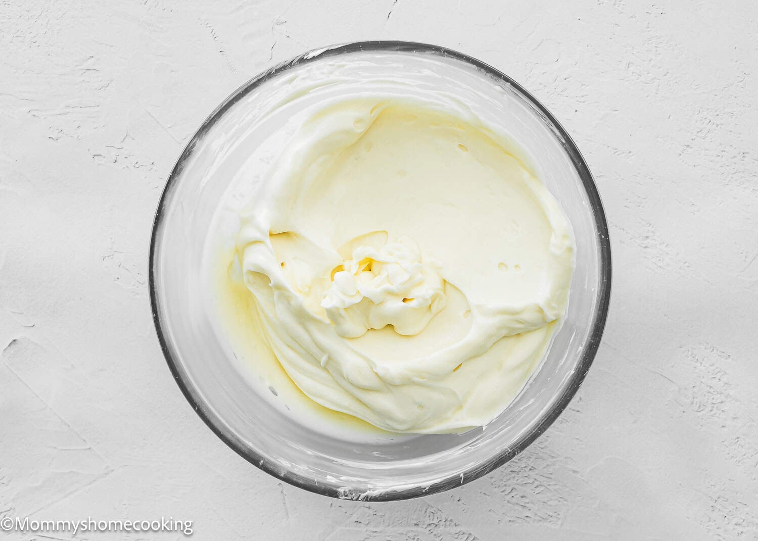 Maple cinnamon rolls icing in a bowl.