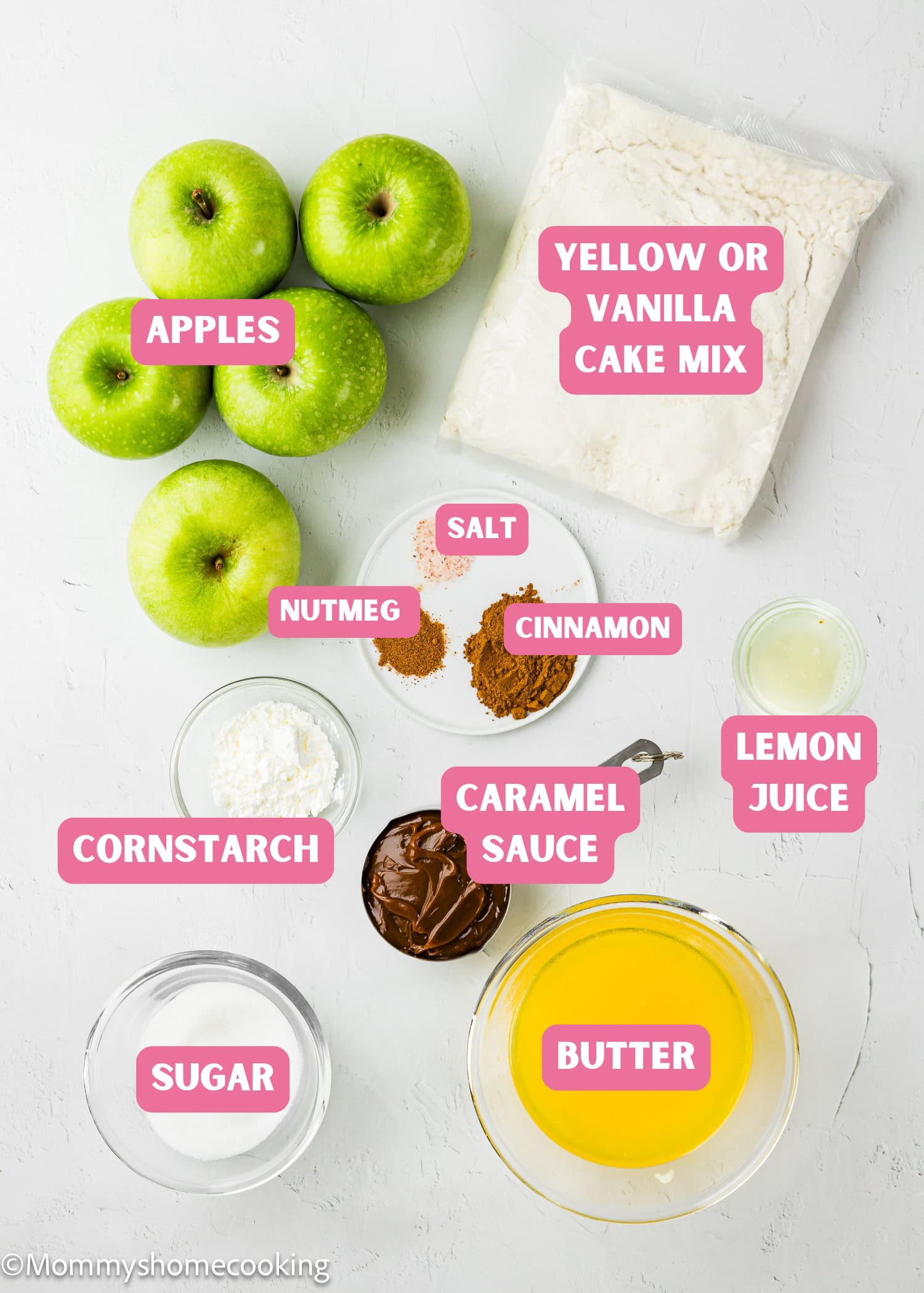 Top-down view of ingredients for Eggless Apple Caramel Dump Cake, including green apples, cake mix, caramel sauce, melted butter, sugar, cornstarch, lemon juice, cinnamon, nutmeg, and salt.