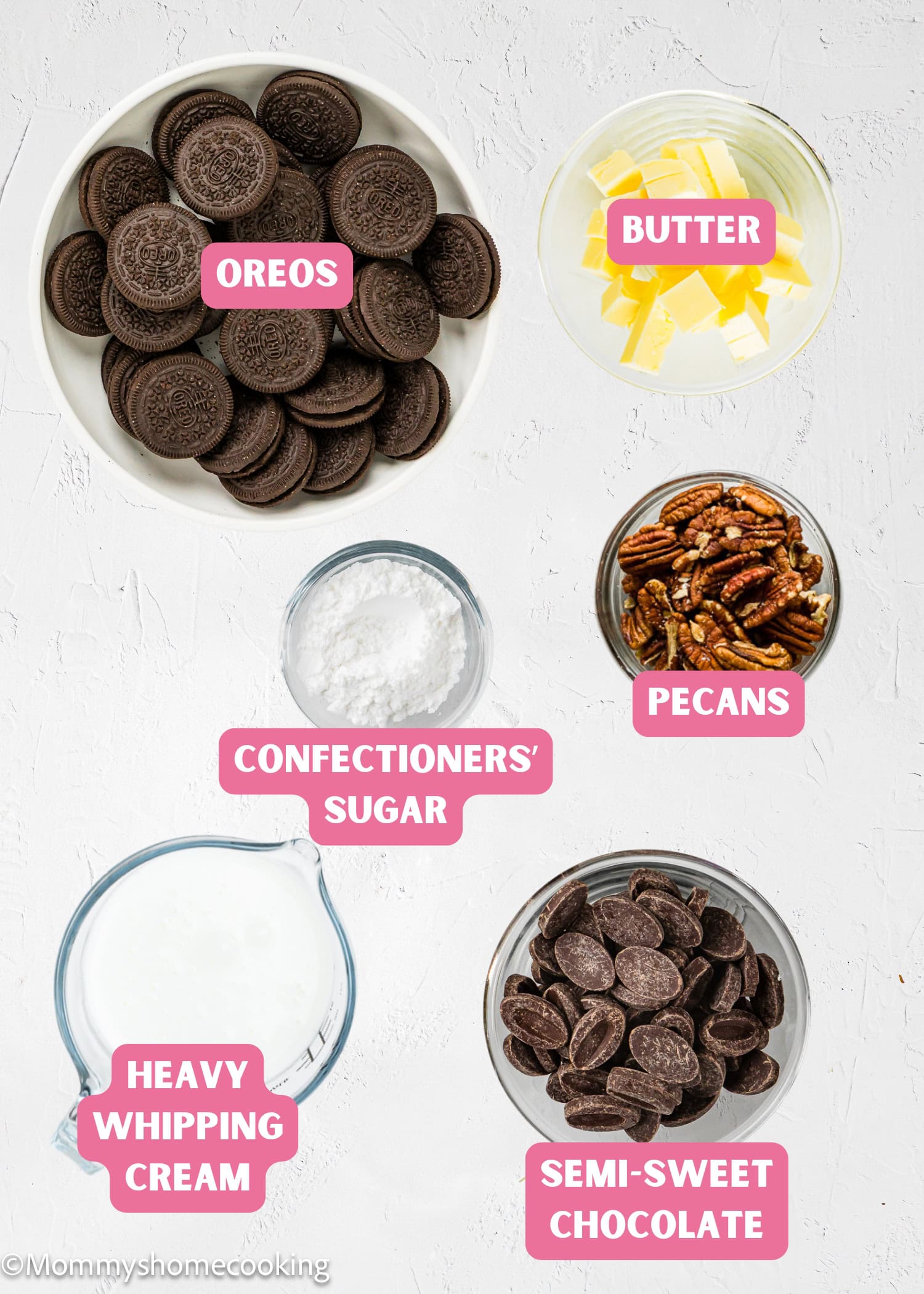 Top view of bowls containing ingredients for Eggless Chocolate Mousse Pie (no-bake): Oreos, butter, confectioners’ sugar, heavy whipping cream, and semi-sweet chocolate, each clearly labeled with text.