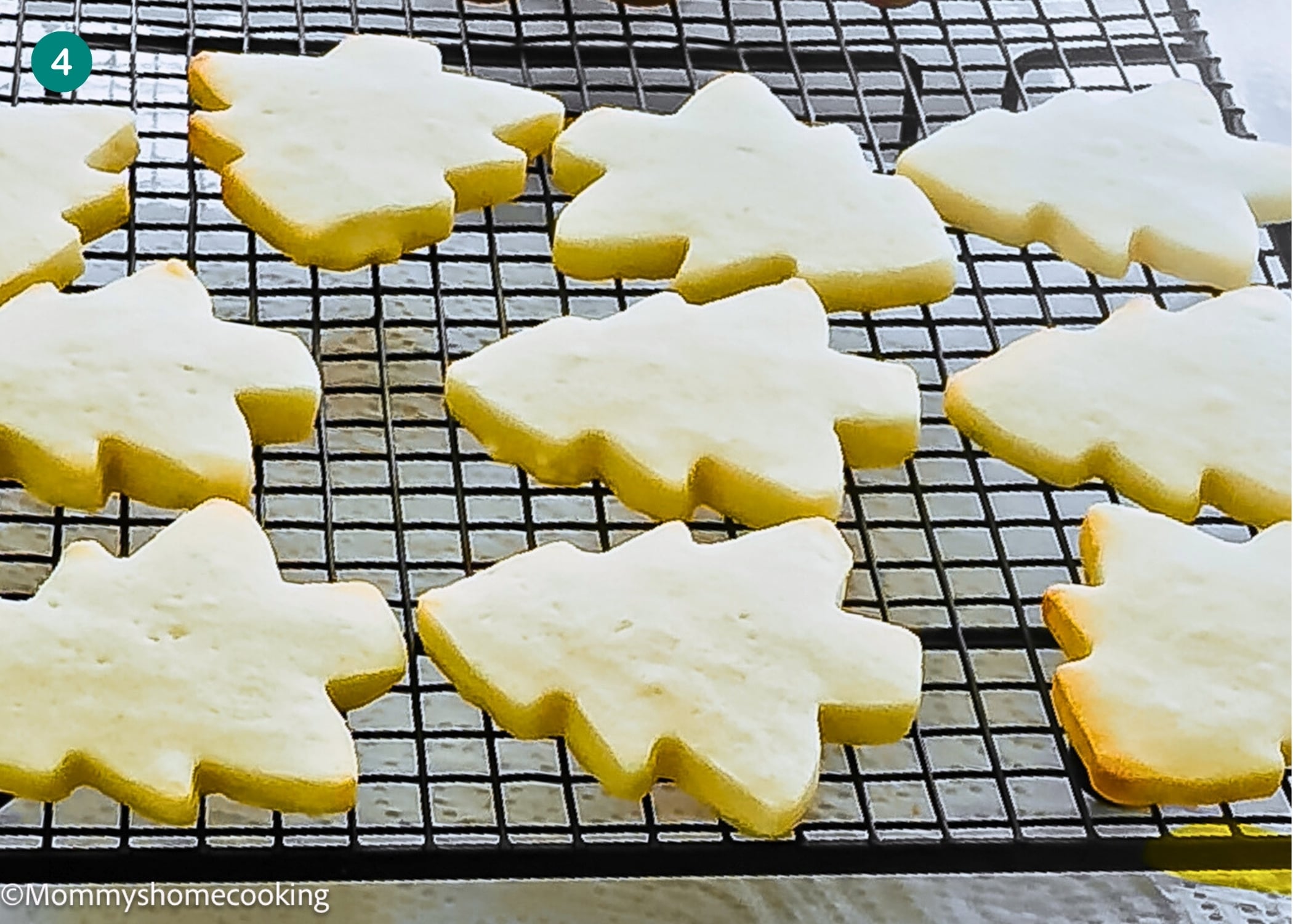 Eggless Marble Christmas Tree Cookies cooling on a black wire rack, shaped perfectly for the festive season.