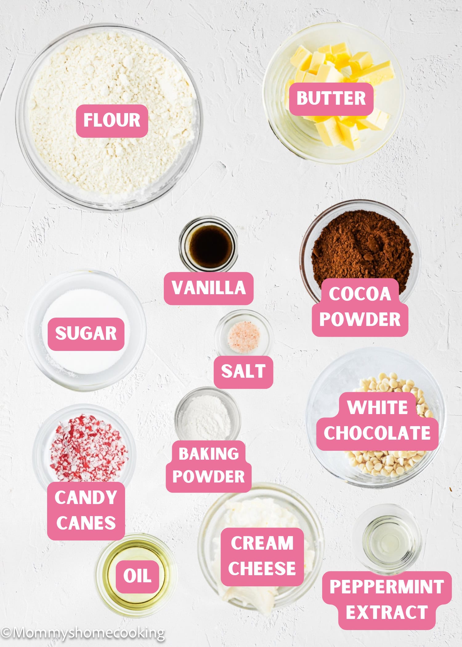 Various baking ingredients, including flour, butter, cocoa powder, cream cheese, crushed candy canes, and peppermint extract—everything you need to create festive Eggless Peppermint Bark Cookies.
