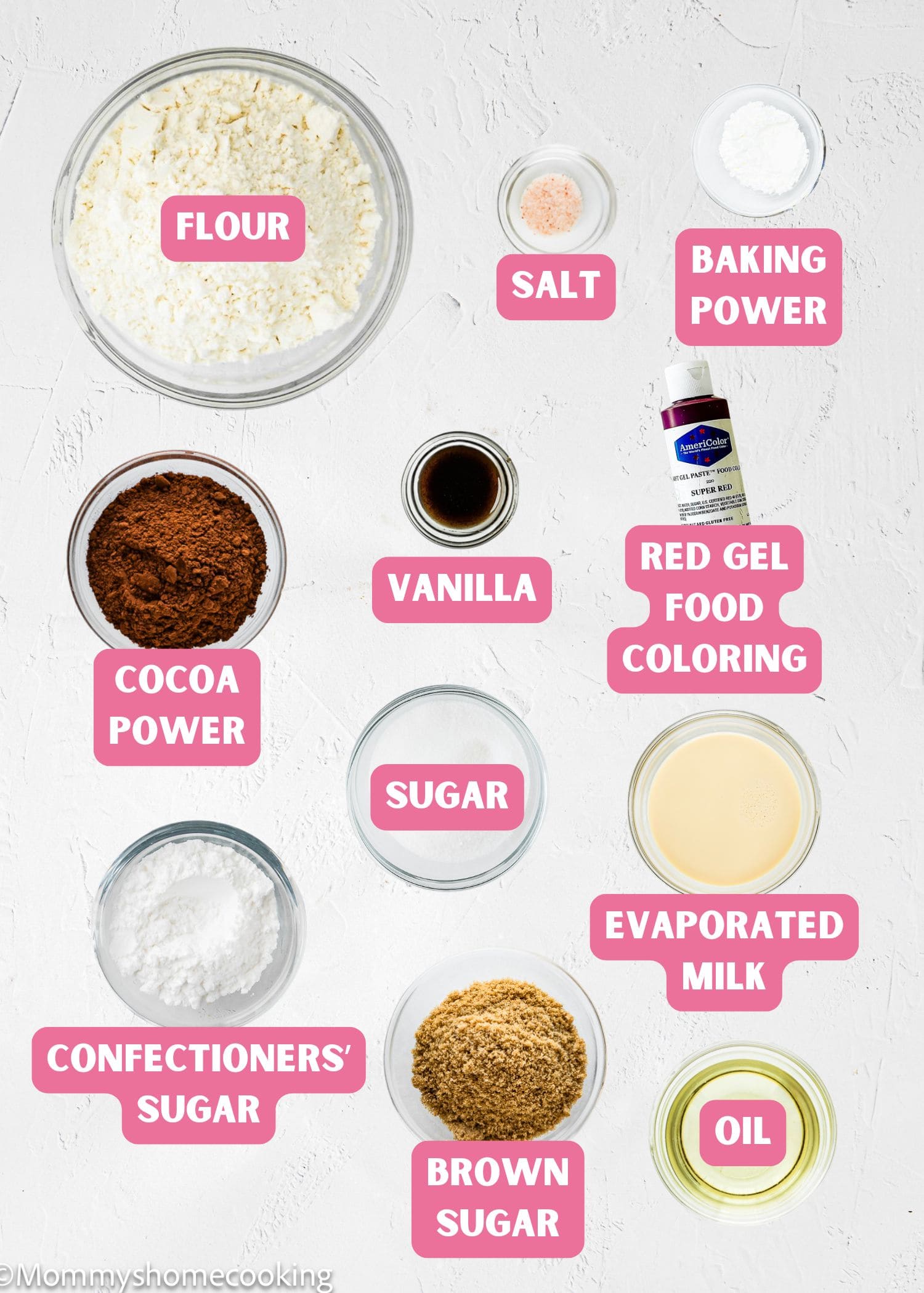 Top-down view of labeled baking ingredients in bowls for Eggless Red Velvet Crinkle Cookies, including flour, salt, baking powder, cocoa powder, vanilla, red gel food coloring, sugars, evaporated milk, and oil.