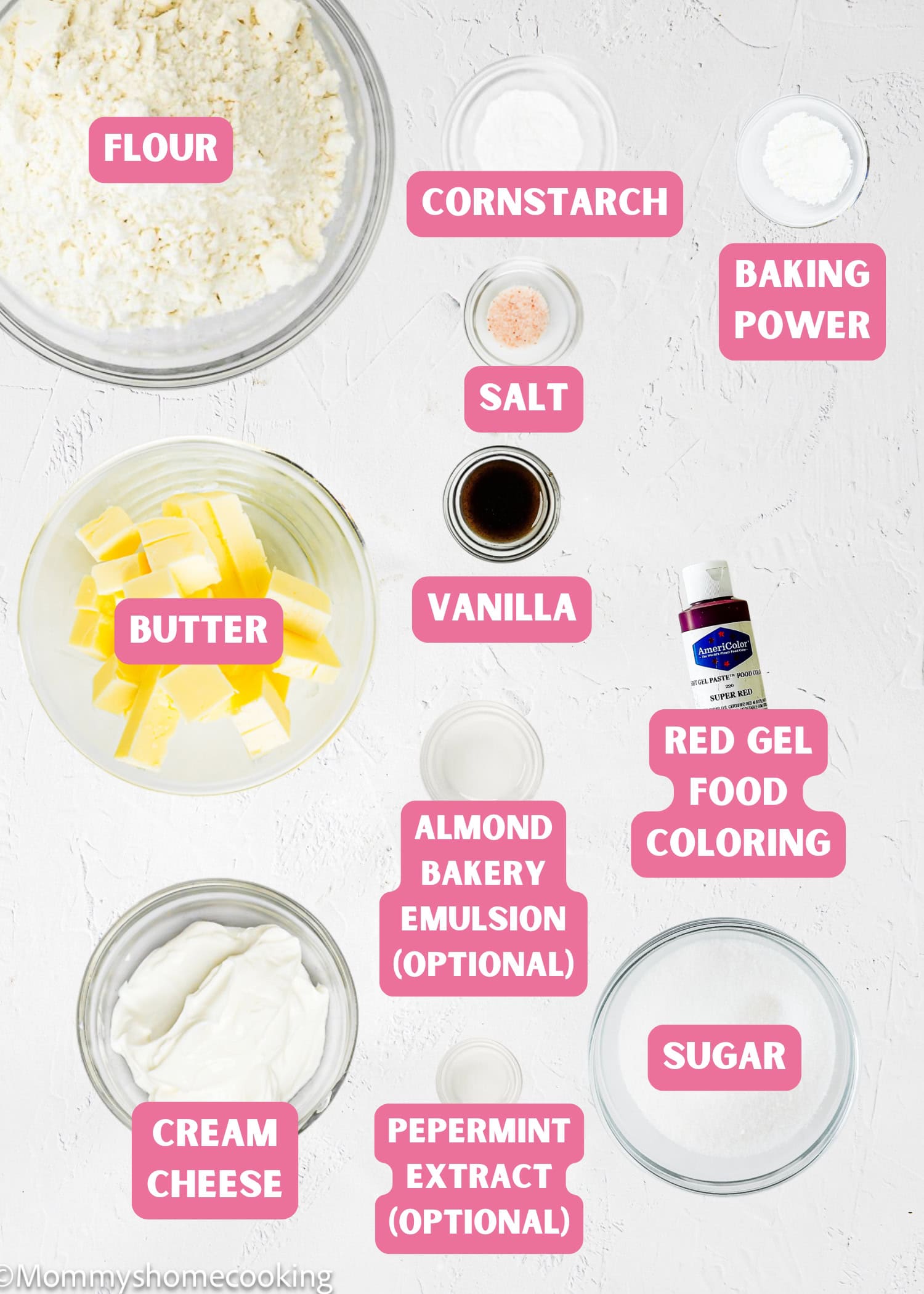 Labeled flat lay of baking ingredients in bowls and dishes for Eggless Candy Canes Cookies, including flour, cornstarch, baking powder, salt, butter, vanilla, red gel food coloring, sugar, and cream cheese.